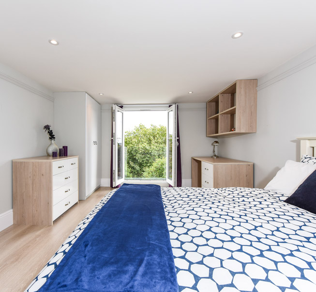 loft-bedroom-in-student-house-with-juliet-balcony